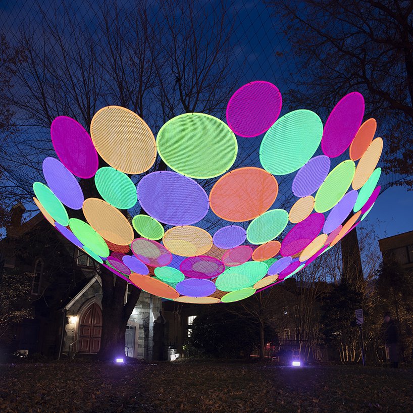 hou de sousa suspends the multi-colored atomic installation in georgetown DC