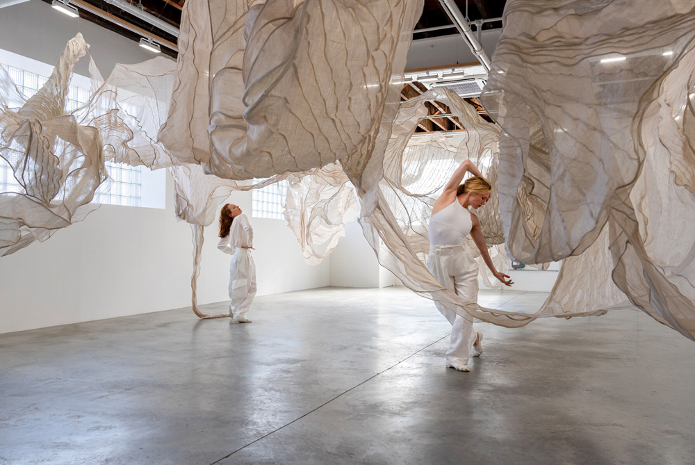 Textile artist diana orving suspends silk organza installation with graceful movements