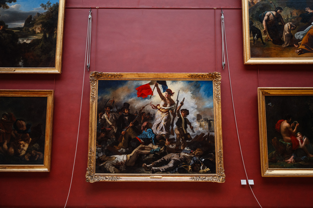 Two Activists Arrested After Sticking Posters Around “Liberty Leading The People” Painting at the Louvre