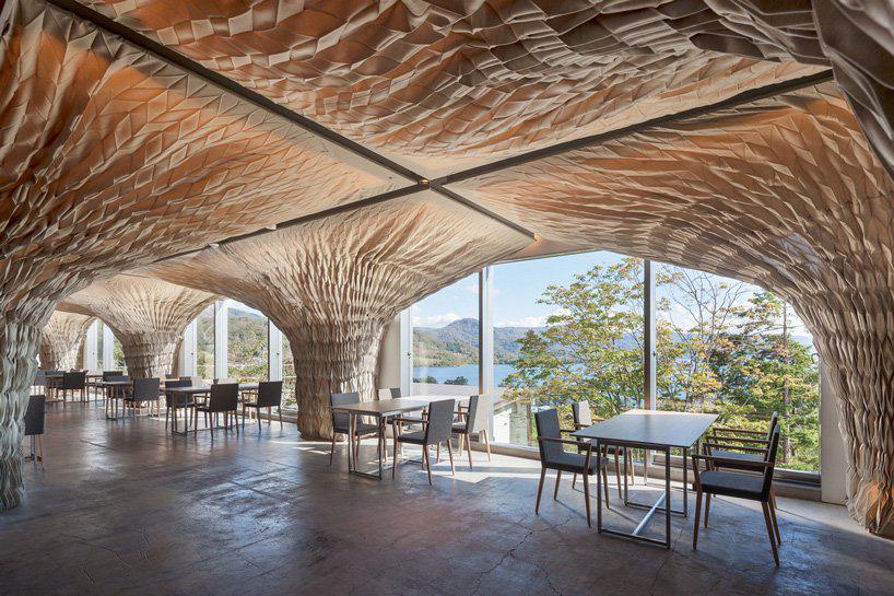 kengo kuma transforms japanese nursing home into the WE hotel toya using fabric and wood