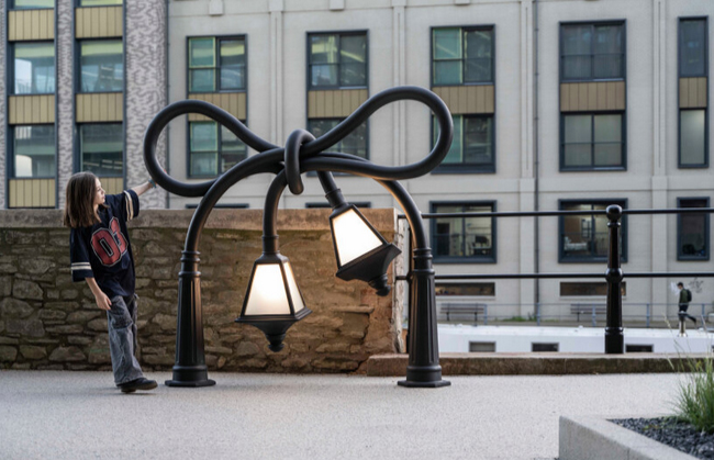 Alex chinneck knots street lamps and twists a phone booth for his assembly bristol sculptures