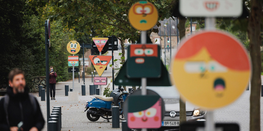 Playful characters pop out of wood campers` customized traffic signs in rennes, france